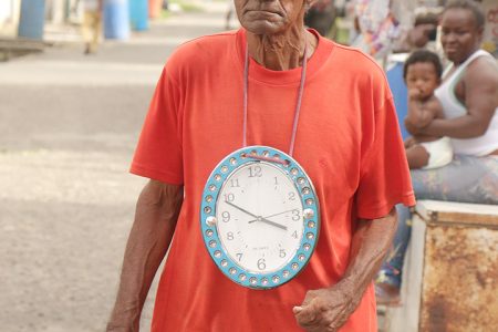 This Albouystown man was walking about today with this clock hanging from his neck.