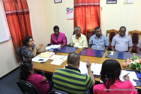Education Minister Priya Manickchand (at head of table) in discussion with some of the contractors. (Ministry of Education photo)