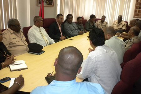 The Minister, the police, miners and others in discussion today. (Ministry of Natural Resources photo)