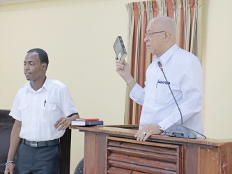 Key witness, former Guyana Defence Force Chief of Staff Norman McLean taking the oath during yesterday’s proceedings.