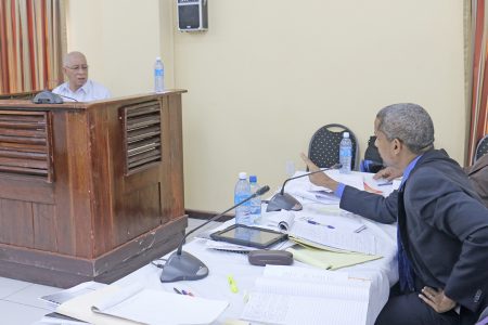 Former Guyana Defence Force Chief of Staff Norman McLean being cross-examined during yesterday’s proceedings by Barbadian lawyer Andrew Pilgrim who is representing the family of Dr Walter Rodney.