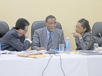 Chairman of the Commission Sir Richard Cheltenham (centre) in dialogue with his fellow commissioners Seenath Jairam (left) and Jacqueline Samuels-Brown during yesterday’s proceedings.