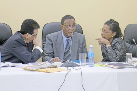 Chairman of the Commission Sir Richard Cheltenham (centre) in dialogue with his fellow commissioners Seenath Jairam (left) and Jacqueline Samuels-Brown during yesterday’s proceedings.