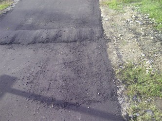 Another section of the roadway showing obvious signs of deterioration
