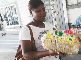 Michelle Sampson holding the spoiled bread she purchased from Graham’s bakery at Stabroek News yesterday.