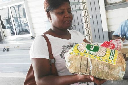 Michelle Sampson holding the spoiled bread she purchased from Graham’s bakery at Stabroek News yesterday.