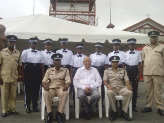 Minister of Home Affairs Clement Rohee being flanked on the right by acting Police Commissioner Seelall Persaud and Assistant Commissioner Balram Persaud and on the left by Traffic Chief Hugh Denhert and ‘A’ Division Commander Clifton Hickens with some of the new traffic wardens.  