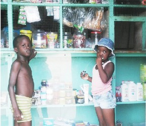 Six-year-old Stanton and four-year-old Renita waiting to buy snacks at a Belfield shop