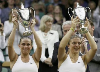 Sara Errani of Italy (R) and Roberta Vinci of Italy celebrate with their winners’ trophies. (Reuters/Stefan Wermuth)