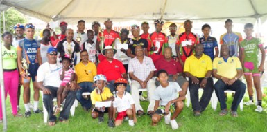 Yesterday’s top performers of the 11th annual CARICOM Day 12-race programme take a photo opportunity with the event’s organizers and the top brass of NAMILCO. (Orlando Charles photo) 