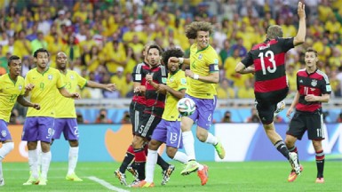 Thomas Mueller (2nd R) of Germany scores his team’s first goal during the 2014 FIFA World Cup Brazil Semi Final match between Brazil and Germany yesterday. (FIFA.com photo)  