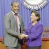 Former Soca Warrior Brent Sancho and Prime Minister Kamla Persad-Bissessar shake hands at the Diplomatic Centre on Monday after she announced that the Government will pay US$1.3million which was owed to members of the team that qualified for the 2006 World Cup.