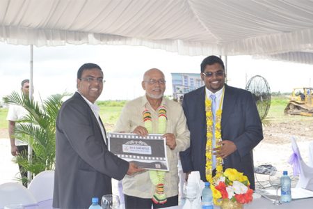 Director of Sun and Sand Hotels Bhushan Chandna (left), President Donald Ramotar (centre) and Tourism Minister Irfaan Ali holding up the hotel plan at the sod turning ceremony yesterday.