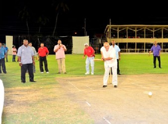 President Donald Ramotar facing the first ball to be played under floodlights at the Albion Sports Ground. (GINA photo) 