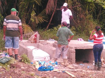 The family of Noel Campo at the vandalised tomb