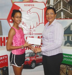 Hand-in-Hand’s Human Resource/Admin Manager, Zaida Joaquin hands over the sponsorship cheque to Sarah Lewis at the company’s Avenue of the Republic Head Office. 