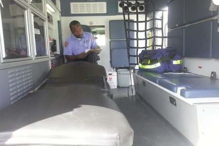 EMT Jermaine Ifill in one of the ambulances used by the Georgetown Public Hospital’s Emergency Medical Service.