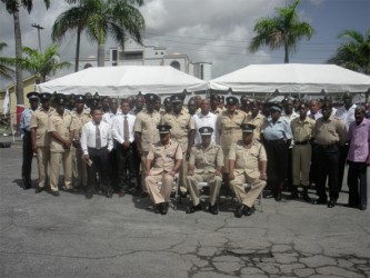 (seated: L to R): Assistant Police Commissioner David Ramnarine, Police Commissioner Seelall Persaud, and Assistant Police Commissioner Balram Persaud with a few of the 1,300 awardees yesterday 