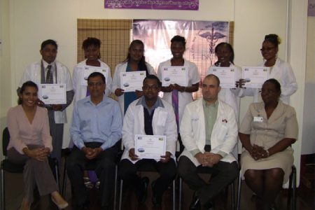 The seven new doctors displaying their certificates, with BRHA CEO Dr Vishwa Mahadeo, Dr Javier Lopez, Matron Lyken and Hospital Superintendent Melissa Ramdeen.  