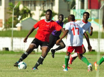 Chase Academy goal scorer Shamar Barrow (left) trying to evade his Morgan Learning Institute marker (No.17) during their match-up