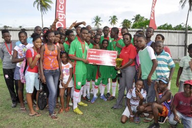 Leonora Secondary captain Scottie Leitch receiving the winner’s cheque and championship trophy from Digicel representative Natasha Taitt while members and supporters of the team look on   