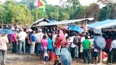 Hundreds of squatters gathered around the makeshift hall from which APNU MP Joseph Harmon addressed them (Photo by Chevy Devonish) 