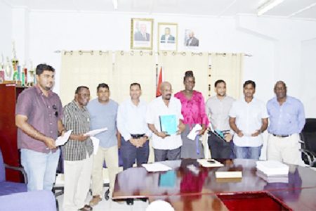 Contractors with Minister of Local Government and Regional Development Norman Whittaker (centre), Permanent Secretary Collin Croal (fourth from left) (GINA photo)
 
