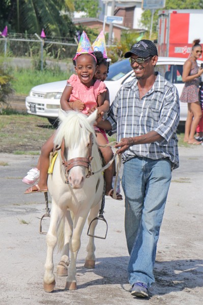 Pony ride: Little girls enjoying a pony ride at the Kiskadee Kids, Blue Sackie Kids and Precious Angels Family Fun Fair at the national Gymnasium, Mandela Avenue yesterday. (Photo by Arian Browne) 
