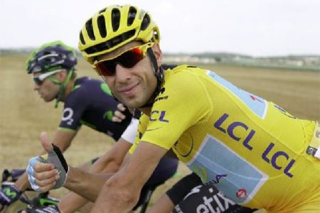 Astana team rider and leader’s yellow jersey holder Vincenzo Nibali of Italy gives thumbs up as he cycles during the 137.5 km final stage of the Tour de France cycling race, from Evry to Paris Champs Elysees, Saturday. CREDIT: REUTERS/GONZALO FUENTES