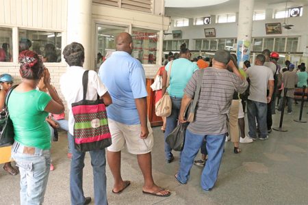 Several persons in this long queue at the Guyana Post Office Corporation yesterday were applying for new birth certificates in keeping with what they had been told at the Central Immigration and Passport Office. (Photo by Arian Browne)