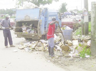 Linden Town Council employees removing refuse dumped outside of the Mackenzie Municipal Market 