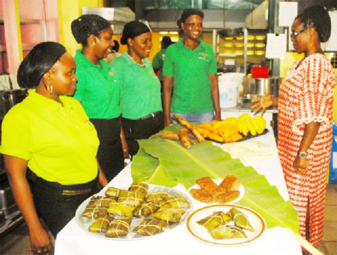 Spicy Dish proprietrix Karen Pollard and members of her staff with a batch of conkee and cassava pone awaiting  delivery