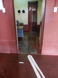 A flooded section of the officer’s station as well as one of the holding cells for prisoners.