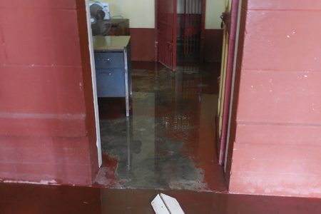 A flooded section of the officer’s station as well as one of the holding cells for prisoners.