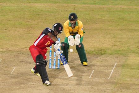 Evin Lewis showing the maker’s name with a text book drive in last night’s action at the National Stadium.
