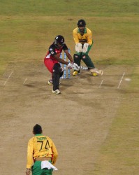 Nicholas Pooran reverse sweeps Sunil Narine for one of his two fours in last night’s action at the National Stadium.