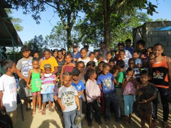 A Guyana Foundation team sharing out school supplies in Meten-Meer-Zorg