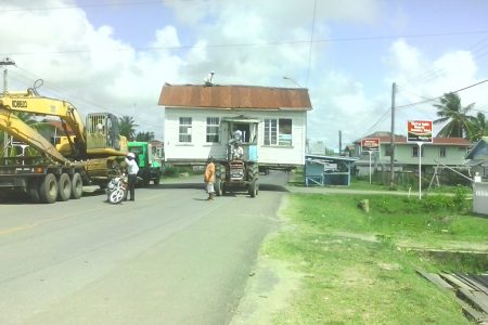 Much care and patience went into moving this house at Lancaster, Corentyne, Berbice on Sunday.