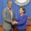 Former Soca Warrior Brent Sancho and Prime Minister Kamla Persad-Bissessar shake hands at the Diplomatic Centre yesterday after she announced that the Government will pay US$1.3million which was owed to members of the team that qualified for the 2006 World Cup