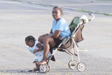 This woman took a spell in a stroller as her child explored her surroundings. This photo was taken at Golden Grove, ECD today.
