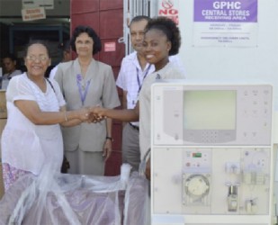 From left: Tara Mohamdee handing over the Dialysis Machine to representatives of the Georgetown Public Hospital Corporation (GPHC). From  right are Nurse in charge of the Renal Department at the GPHC, O’Delevana Kennedy, and CEO of the GPHC Michael Khan with another representative from the hospital. (GINA photo) 