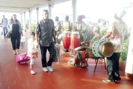 Welcoming party: Hundreds of arriving passengers were greeted to the beats of African drums on Thursday when they touched down at the Cheddi Jagan International Airport, Timehri (CJIA). In a statement, the airport said its 2014 Emancipation observance saw arriving travelers treated to the pulsating rhythms by the Otishka Group in addition to African delicacies, such as conkie and cassava pone. The treats were served by the Airport’s Customer Service Representatives and employees of the Commercial and Administration Department. The event is an annual one to observe national holidays in an effort to give passengers the experience of Guyana’s diverse cultures, the CJIA stated. (CJIA photo)
