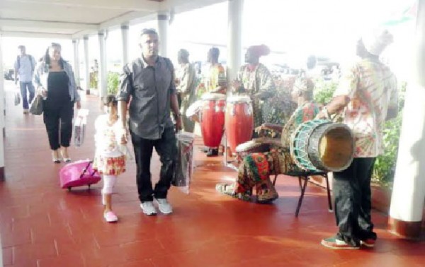 Welcoming party: Hundreds of arriving passengers were greeted to the beats of African drums on Thursday when they touched down at the Cheddi Jagan International Airport, Timehri (CJIA). In a statement, the airport said its 2014 Emancipation observance saw arriving travelers treated to the pulsating rhythms by the Otishka Group in addition to African delicacies, such as conkie and cassava pone. The treats were served by the Airport’s Customer Service Representatives and employees of the Commercial and Administration Department. The event is an annual one to observe national holidays in an effort to give passengers the experience of Guyana’s diverse cultures, the CJIA stated. (CJIA photo) 