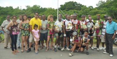 Winners and runners up of this year’s 10th annual Reagan Rodrigues road race pose with their winning spoils with Hassan Mohamed and members of the Rodrigues’ family. (Orlando Charles photo) 