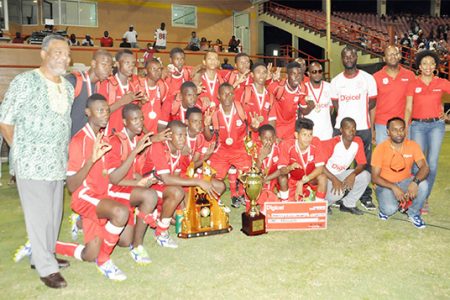 Newly crowned three time defending national champions Christianburg/Wismar Secondary posing with their championship trophy, medals and prize money while Prime Minister Samuel Hinds (extreme left) and representatives of tourney sponsors Digicel look on
