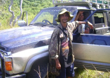 Kooldeep Looknauth standing outside of the jeep on one of his trips in the interior.