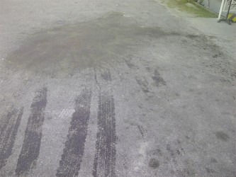 Waste oil residue in the Ogle International Airport Parking Lot after the attack