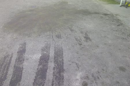 Waste oil residue in the Ogle International Airport Parking Lot after the attack