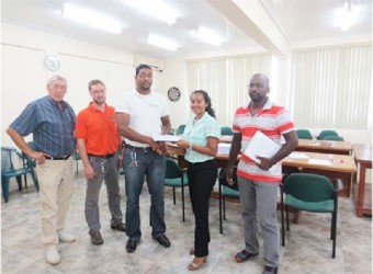 Senior Environmental Officer at EPA,  Bibi Sharief (second from right) presented contracts to the Project Contractor, Alvin Chowramootoo (right), and IECS Representative, Deoraj Dalchand (centre) for Supervision of the Project. Also in this ministry photo, from left, are Ben ter Welle (Team Leader, GFA Consulting Group), and Joel Breems (Protected Areas Commission Representative). 