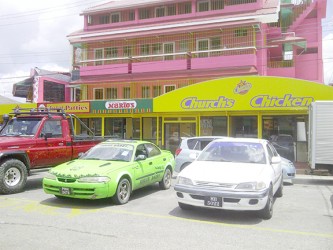 A fleet of hire cars parked in front of the fast food franchises located at Bukhan’s rental complex